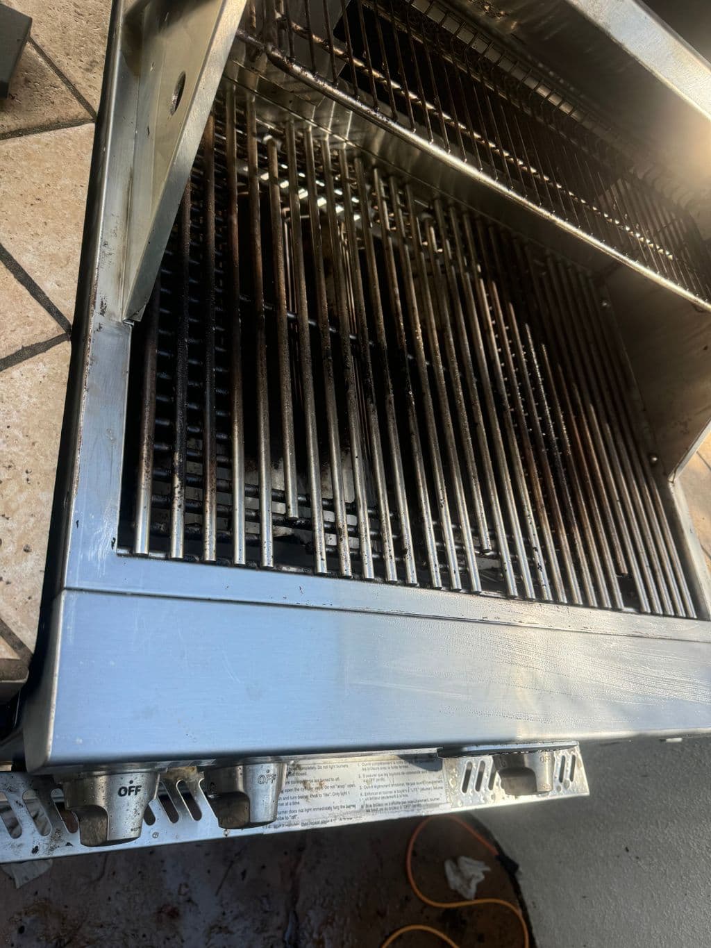 Cleaned stainless steel grill grates and burner area. Work by Construction Hub in Los Angeles.
