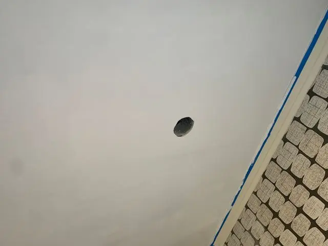 Smoothed white ceiling with taped edge and open electrical box. Work by Construction Hub in Los Angeles.