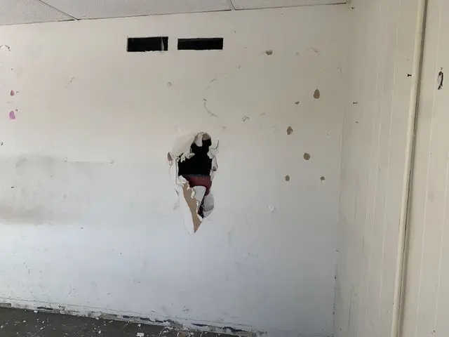 Wall with a large broken hole and scattered gouges in drywall. Work by Construction Hub in Los Angeles.