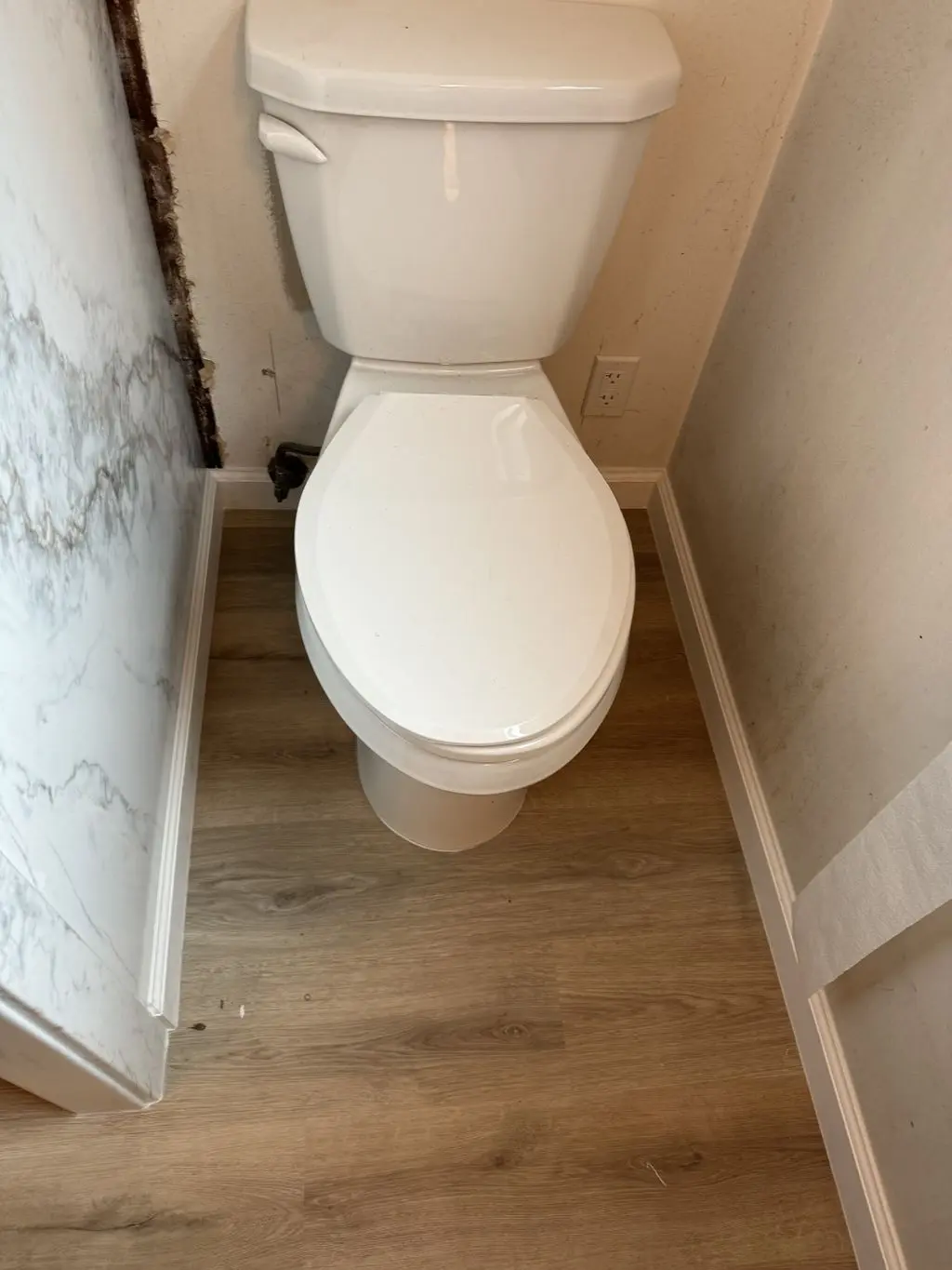 New two-piece toilet installed on vinyl plank floor. Work by Construction Hub in Los Angeles.