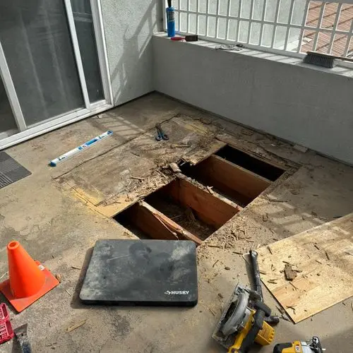 Balcony decking cut open exposing joists during repair work. Work by Construction Hub in Los Angeles.