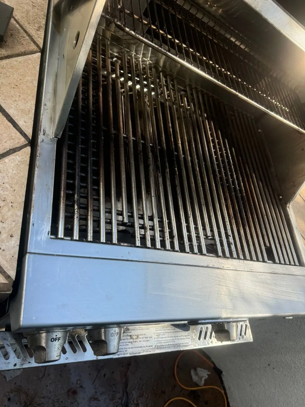 Cleaned stainless steel grill grates and burner area. Work by Construction Hub in Los Angeles.