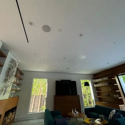 Living room ceiling with recessed lights and flush mount speakers. Work by Construction Hub in Los Angeles.