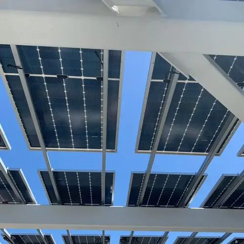 Solar panel patio cover viewed from below with white beams. Work by Construction Hub in Los Angeles.