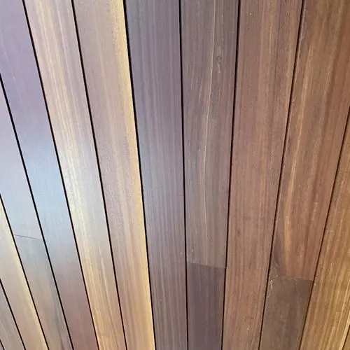 Close up of tight fitted hardwood boards in mixed brown tones. Work by Construction Hub in Los Angeles.