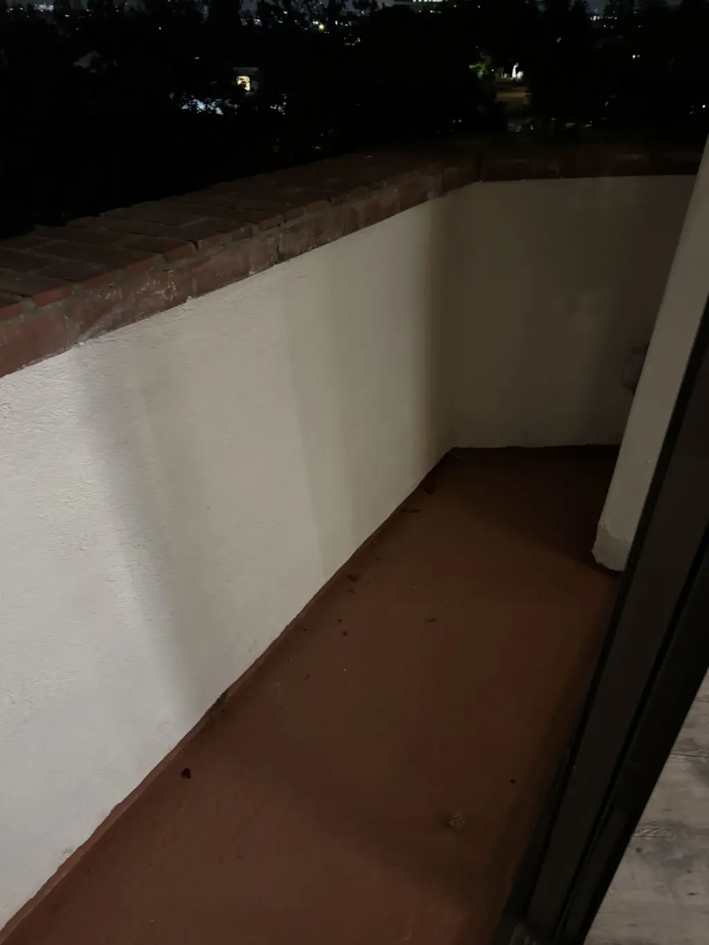 Repainted white balcony walls with red tile floor. Work by Construction Hub in Los Angeles.