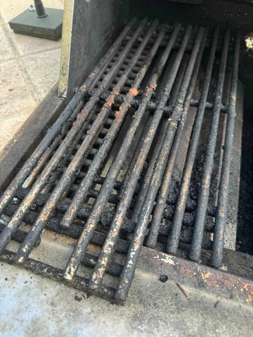 Built-in grill grates caked with grease and burnt residue. Before the work, by Construction Hub in Los Angeles.