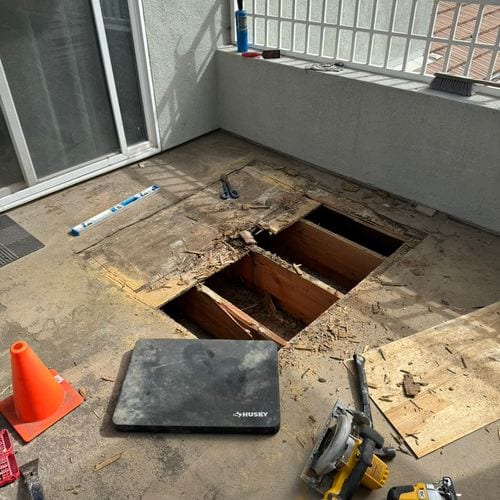 Balcony decking cut open exposing joists during repair work. Work by Construction Hub in Los Angeles.