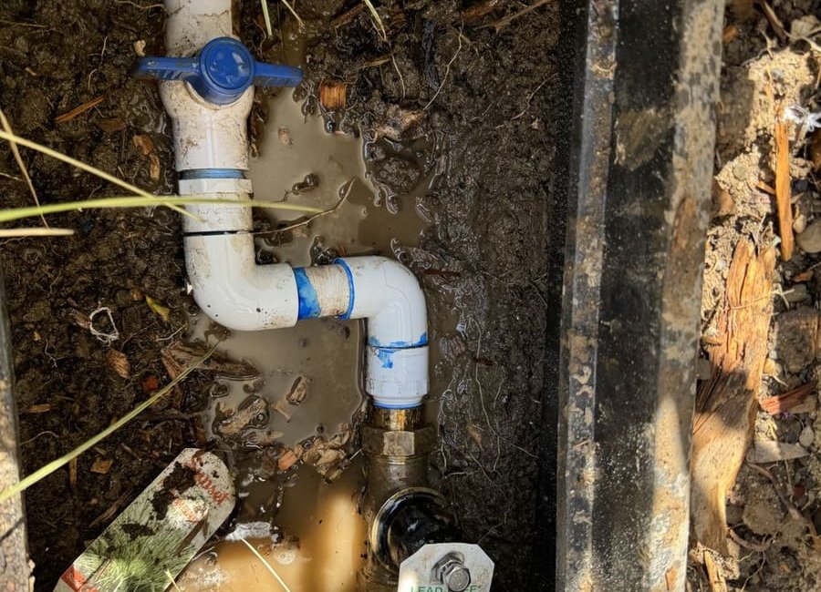 Irrigation valve box with PVC piping, a blue ball valve and a brass fitting. Work by Construction Hub in Los Angeles.