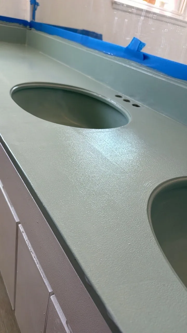 Vanity countertop and sink refinished in mint green, edges still taped