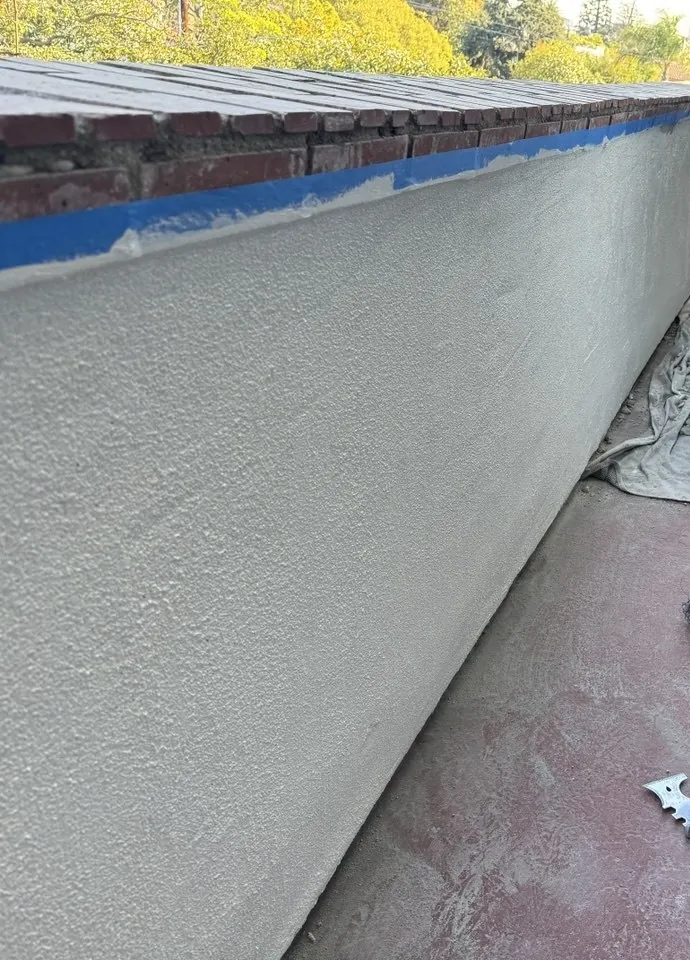 Parapet wall with fresh stucco and taped brick cap, Beverly Hills